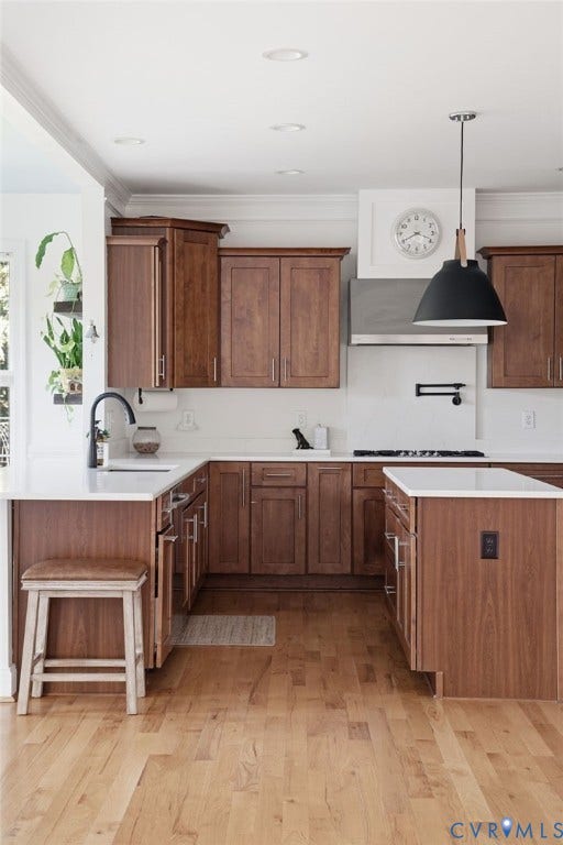 4502 Jennway Turn, Summer Lake, Moseley, VA 23120 Kitchen featuring stained wood cabinetry, stone countertops, stainless steel range hood, wall-mounted pot filler, and wood-finish flooring