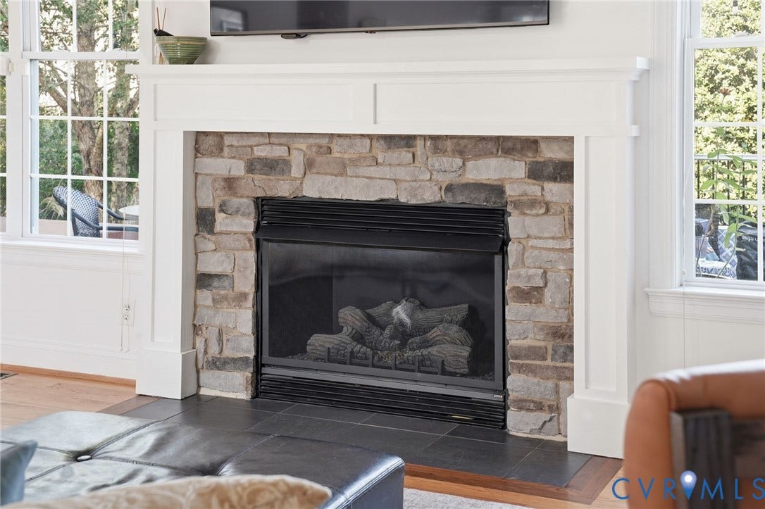 4502 Jennway Turn, Summer Lake, Moseley, VA 23120 Fireplace featuring a stone surround, white wood-finish mantel, and black tile hearth