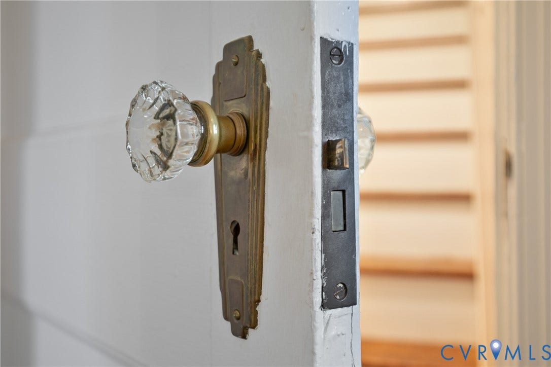 3006 Porter Street, Richmond, VA 23225 Art deco-style brass door hardware featuring a faceted glass knob and integrated keyhole escutcheon plate