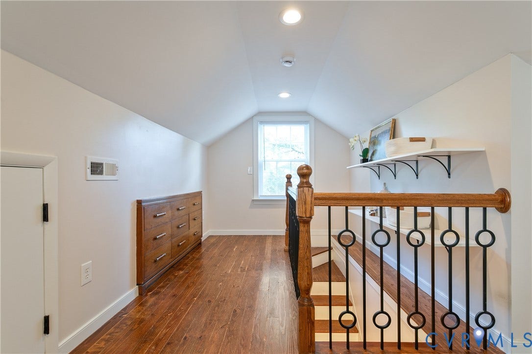3006 Porter Street, Richmond, VA 23225 Vaulted ceiling with recessed lighting, wood-finish flooring, custom built-in wooden cabinetry, and decorative metal railings with wooden banister