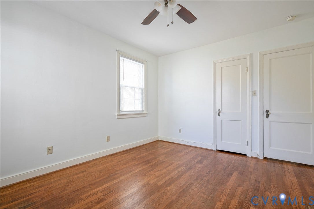 3006 Porter Street, Richmond, VA 23225 Room featuring wood-finish flooring, a single-hung window, white interior walls, and a ceiling-mounted light fixture with a fan