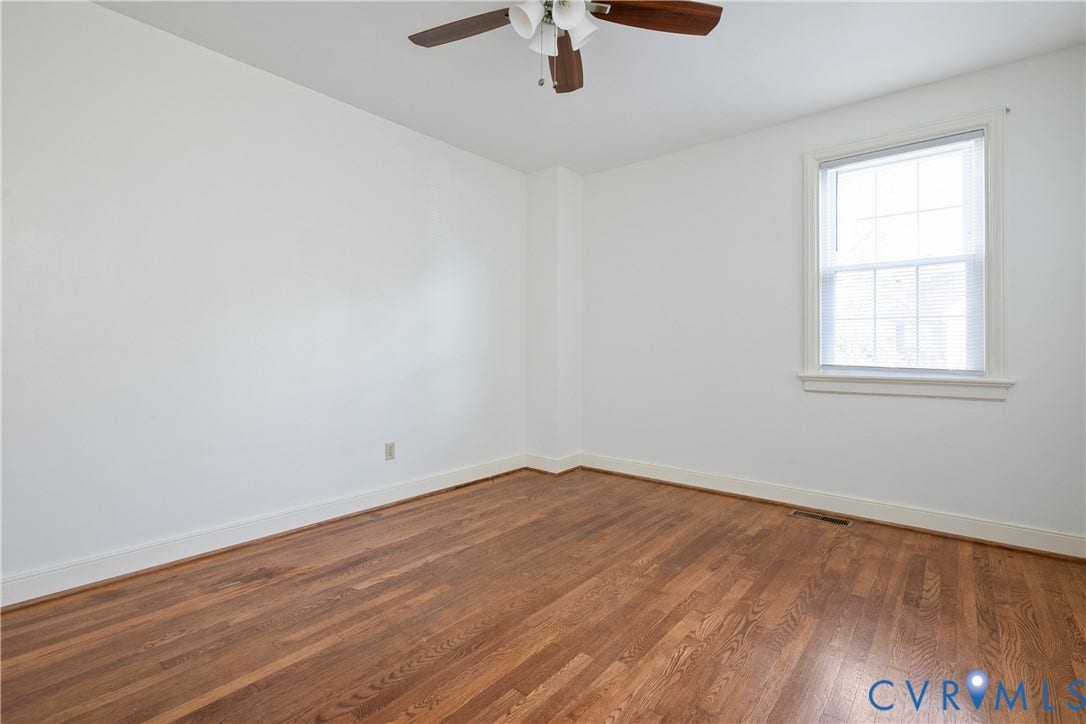 3006 Porter Street, Richmond, VA 23225 Neutral wall tones, wood-finish flooring, multi-pane window, and a central ceiling fan with integrated lighting