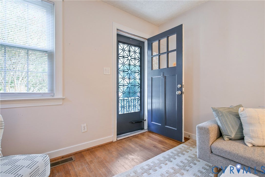 3006 Porter Street, Richmond, VA 23225 Entryway featuring wood-finish flooring, a multi-pane glass entry door with a decorative metal security screen, and a large window with blind attachments