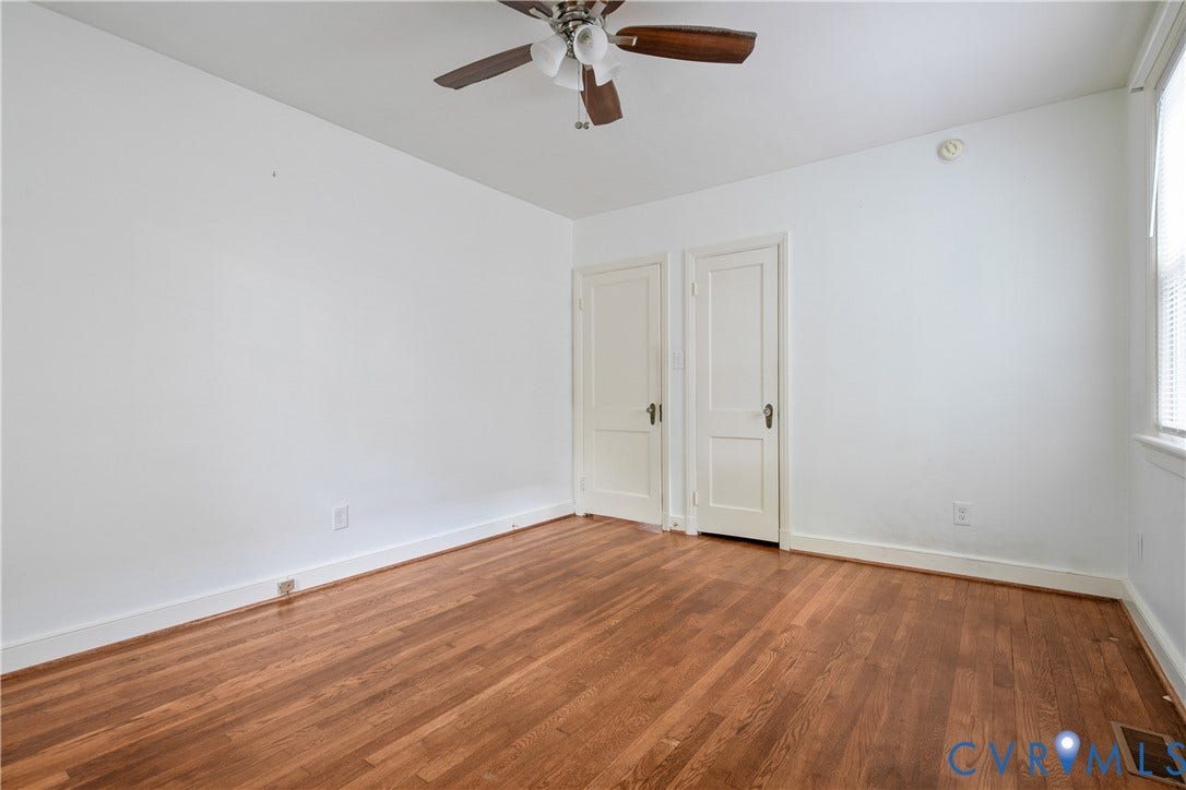3006 Porter Street, Richmond, VA 23225 Interior room featuring wood-finish flooring, two-panel interior doors with brass hardware, and a ceiling-mounted light fixture with a central fan
