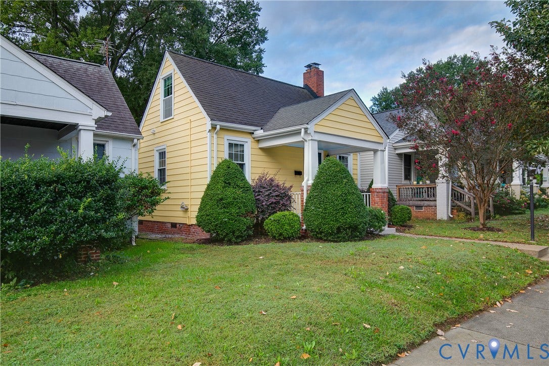 3006 Porter Street, Richmond, VA 23225 Yellow lap siding exterior featuring a covered front porch, brick chimney, multi-pane windows, and a steep gable roofline