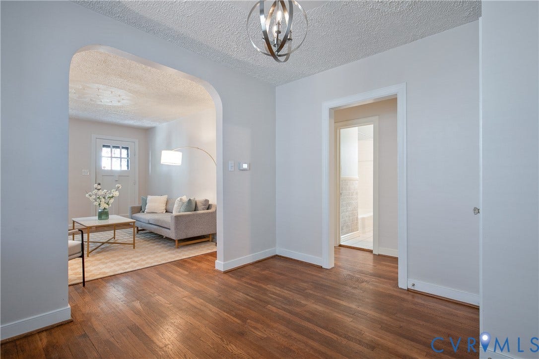 3006 Porter Street, Richmond, VA 23225 Wood-finish flooring, architectural arched doorway, and contemporary metallic orb pendant lighting