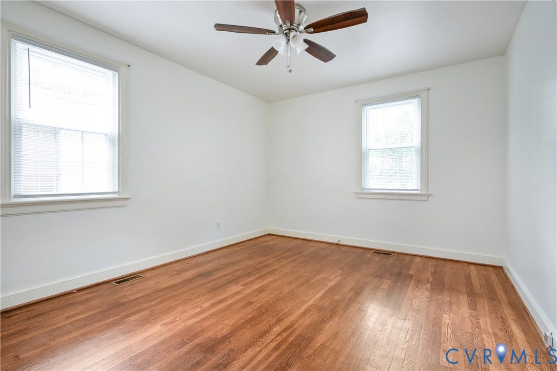 3006 Porter Street, Richmond, VA 23225 Room featuring wood-finish flooring, dual windows with blinds, and a central ceiling fan with integrated lighting