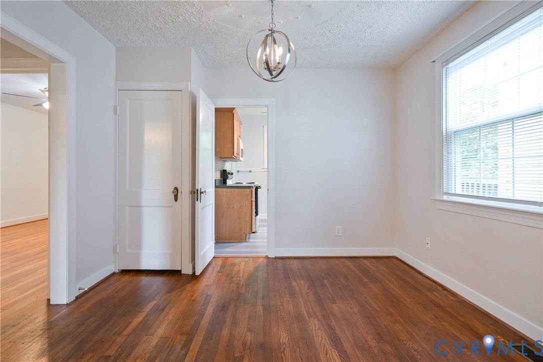 3006 Porter Street, Richmond, VA 23225 Hardwood flooring, orb-style chandelier, multi-pane window, and classic panel interior doors