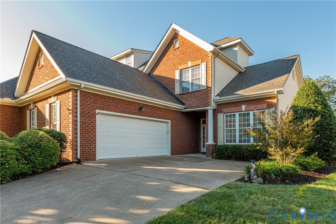 3360 Manor Grove Circle, Glen Allen, VA 23059 Multi-gabled brick and siding exterior featuring a dual-car garage, multi-paned windows with shutters, and manicured landscaping