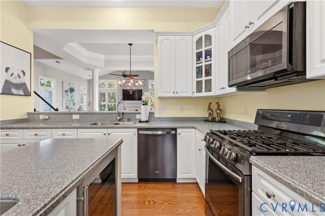 3360 Manor Grove Circle, Glen Allen, VA 23059 Kitchen featuring white cabinetry with glass-front display doors, speckled stone-finish countertops, stainless steel appliances, a gas range, and wood-finish flooring