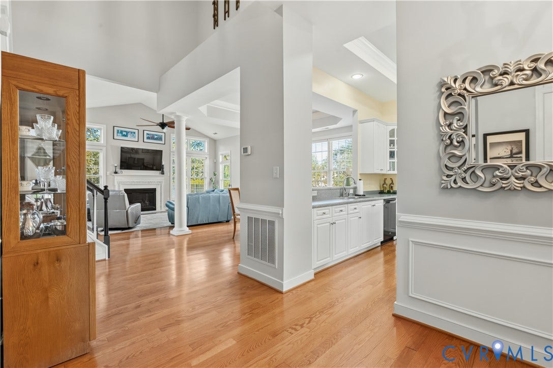 3360 Manor Grove Circle, Glen Allen, VA 23059 Vaulted ceilings, wood-finish flooring, column detailing, recessed lighting, and white cabinetry