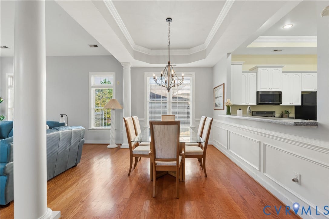 3360 Manor Grove Circle, Glen Allen, VA 23059 Dining area featuring wood-finish flooring, a tray ceiling with a multi-arm chandelier, and decorative wall molding