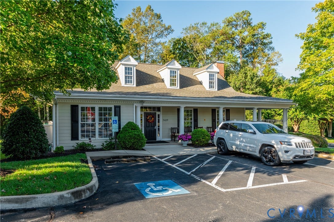3360 Manor Grove Circle, Glen Allen, VA 23059 Colonial-style exterior featuring a covered front porch with support columns, three dormer windows, lap siding, and a multi-car paved parking area
