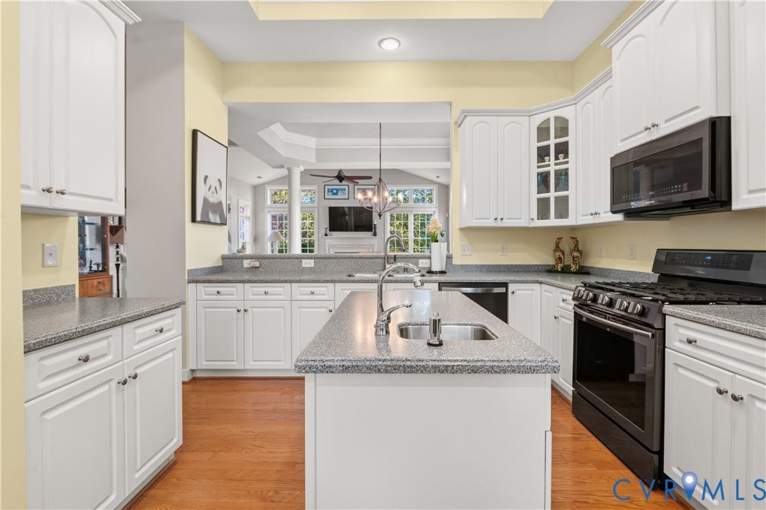 3360 Manor Grove Circle, Glen Allen, VA 23059 Kitchen featuring white cabinetry, center island, stone-finish countertops, wood-finish flooring, and black built-in appliances