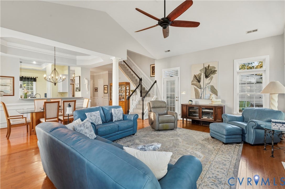 3360 Manor Grove Circle, Glen Allen, VA 23059 Vaulted ceilings featuring a central paddle fan, wood-finish flooring, a classic column, and a staircase with a wooden handrail
