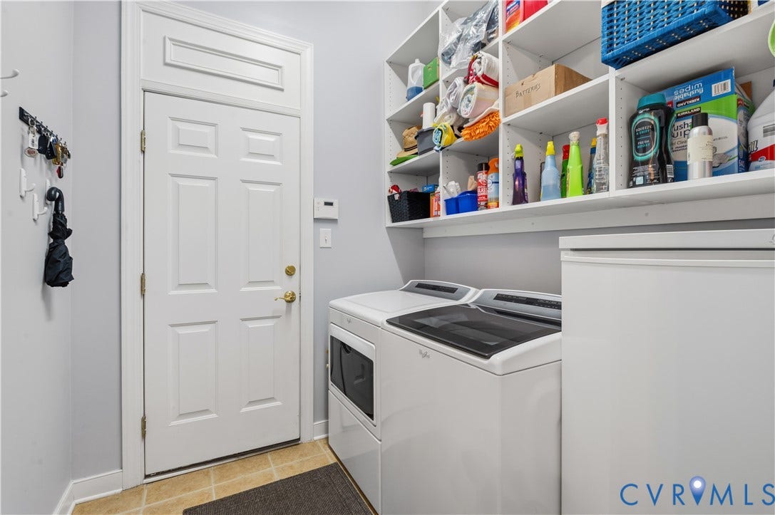 3360 Manor Grove Circle, Glen Allen, VA 23059 Utility room featuring white built-in shelving, tile flooring, and a solid-panel door with brass-finish hardware