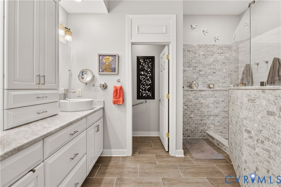 3360 Manor Grove Circle, Glen Allen, VA 23059 Bathroom featuring a white vanity with a stone countertop, vessel sink, walk-in shower with textured stone-style tile surround, and tile flooring