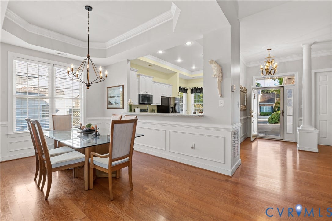 3360 Manor Grove Circle, Glen Allen, VA 23059 Tray ceiling, wood-finish flooring, wainscoting, decorative columns, and chandelier lighting