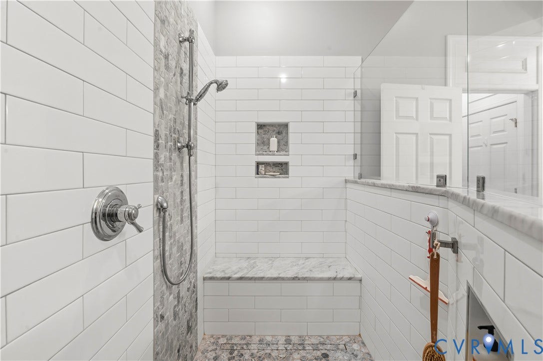 3360 Manor Grove Circle, Glen Allen, VA 23059 Walk-in shower featuring subway tile walls, a built-in stone-topped bench, mosaic stone shower floor, dual built-in recessed niches, and a glass partition