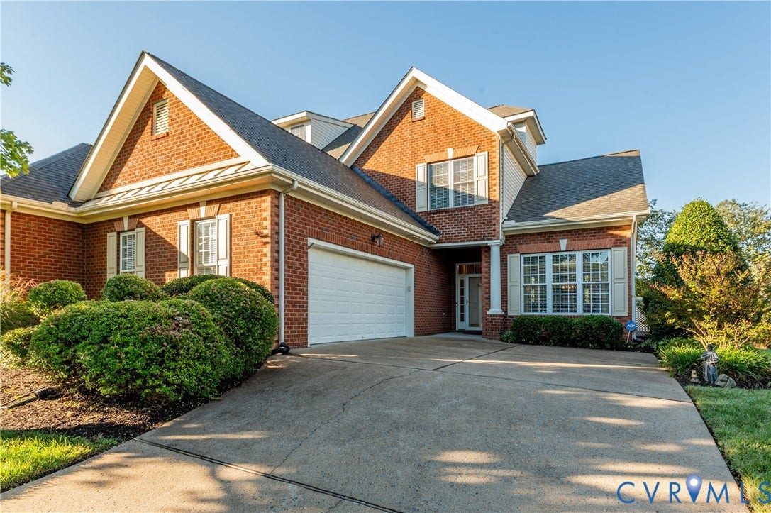 3360 Manor Grove Circle, Glen Allen, VA 23059 Two-story brick exterior featuring a multi-gabled roofline, concrete driveway, and attached two-car garage