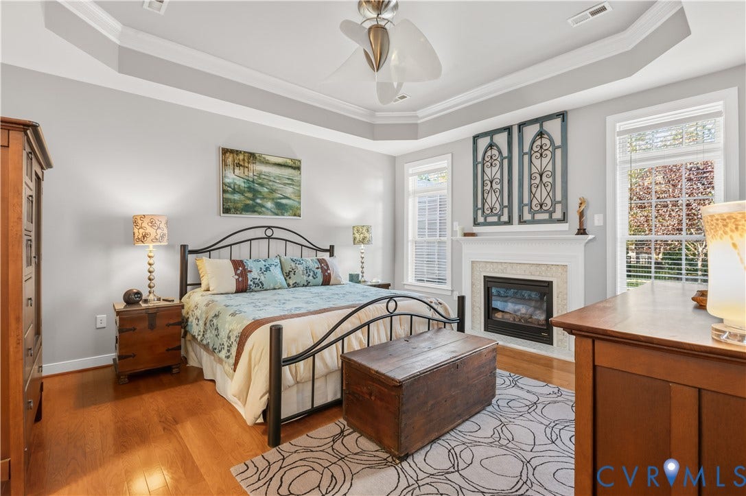 3360 Manor Grove Circle, Glen Allen, VA 23059 Tray ceiling, wood-finish flooring, and fireplace with a decorative tile surround and mantel