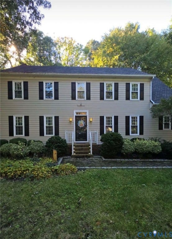 2611 Northwind Drive, The Colonies At Wilde Lake, Henrico, VA 23233 Two-story colonial exterior featuring neutral horizontal siding, dark decorative shutters, a multi-pane front entry door, brick front steps, and a stone-edged walkway