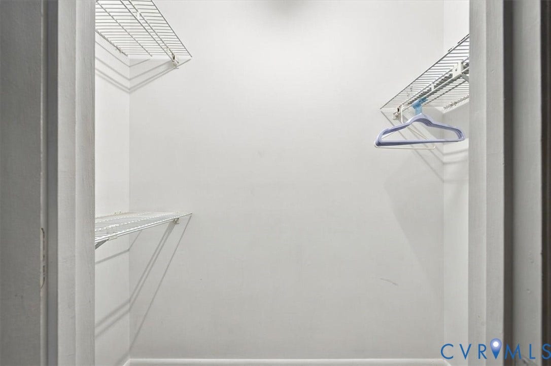 Storage space featuring multi-level white wire shelving