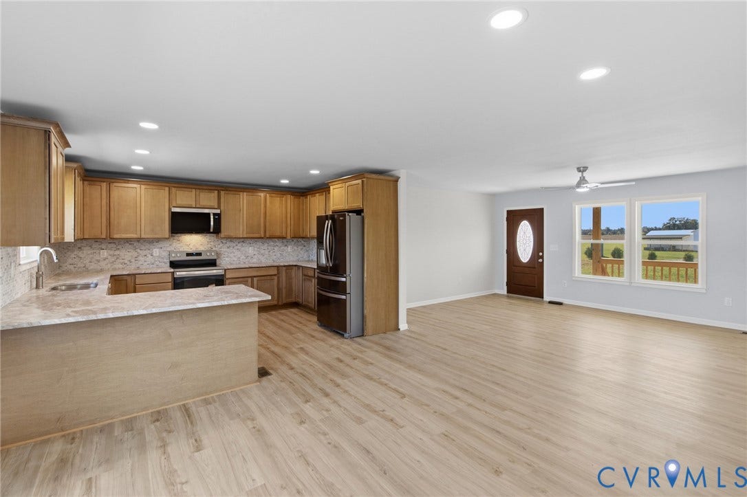 79 Dixie Drive, Mathews, VA 23050 Open-concept interior featuring wood-finish flooring, recessed lighting, shaker-style wood cabinetry, stone-finish countertops, and stainless steel appliances