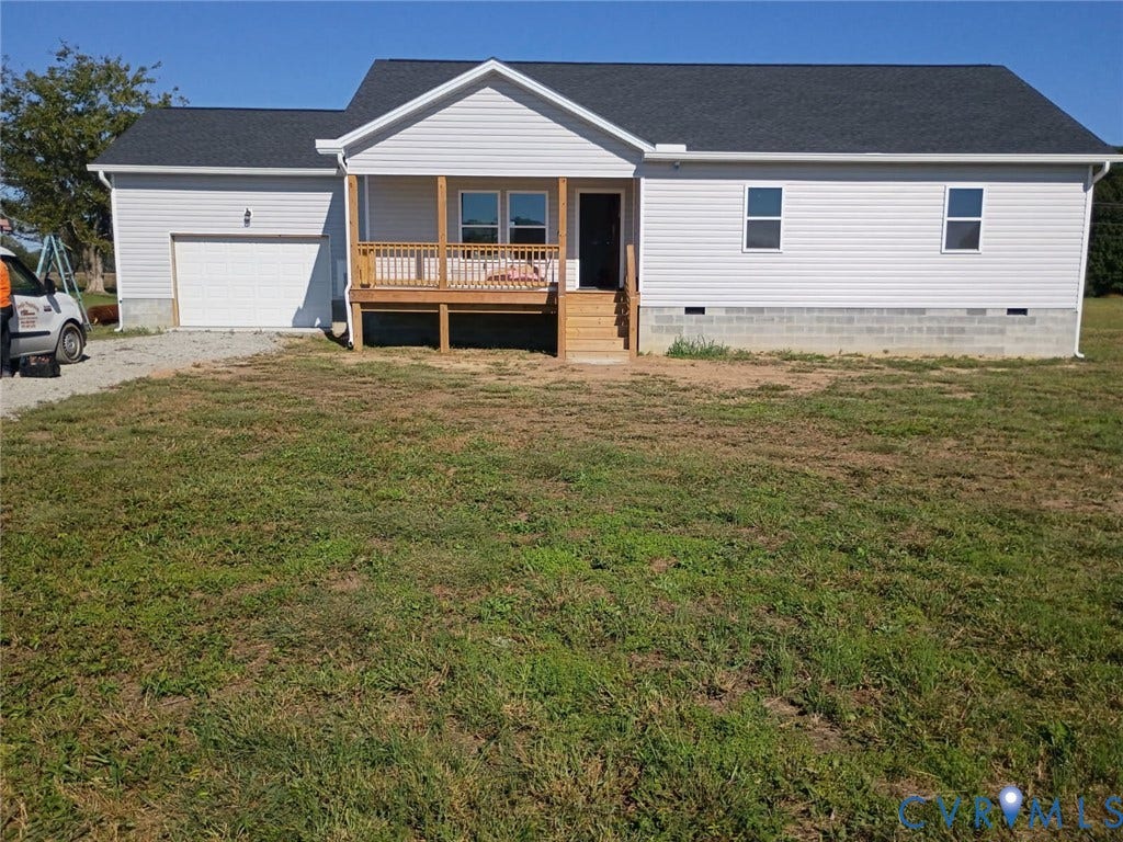 757 Dixie Drive, Mathews, VA 23050 Ranch-style exterior featuring light-colored horizontal siding, a dark shingle roof, a covered wooden front porch with railing, and an attached single-car garage