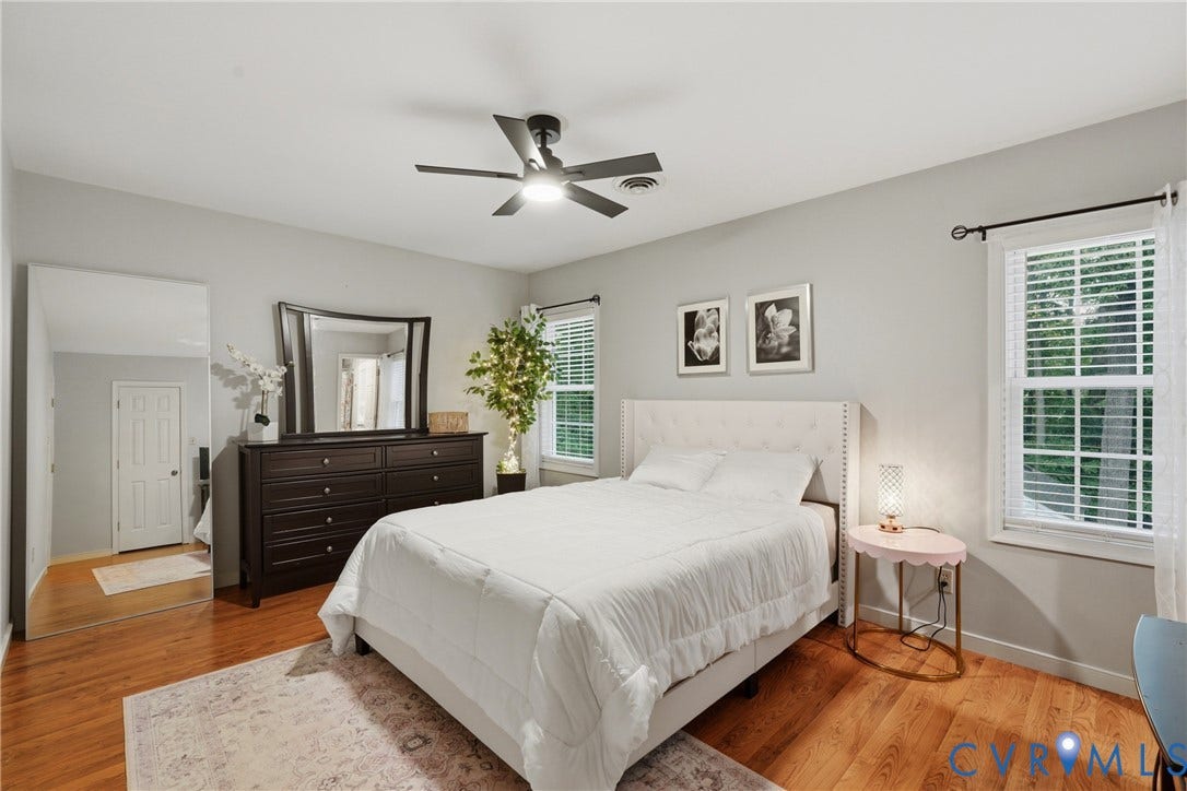 14800 Highberry Woods Drive, Midlothian, VA 23112 Wood-finish flooring, central ceiling fan with integrated lighting, neutral wall paint, and multi-pane windows with horizontal blinds