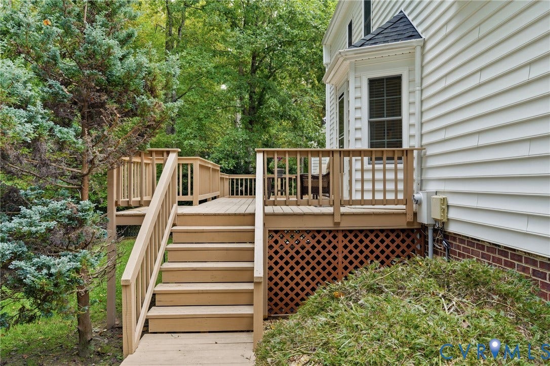 14800 Highberry Woods Drive, Midlothian, VA 23112 Raised wood deck featuring vertical balusters, staircase with handrails, and wood lattice skirting