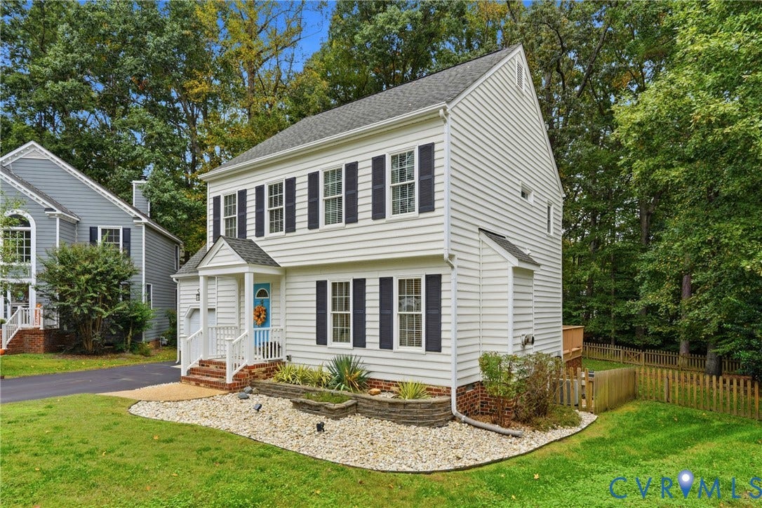 14800 Highberry Woods Drive, Midlothian, VA 23112 Two-story colonial exterior with white horizontal siding, dark shutters, covered front porch, brick-accented foundation, and tiered stone landscape retaining walls