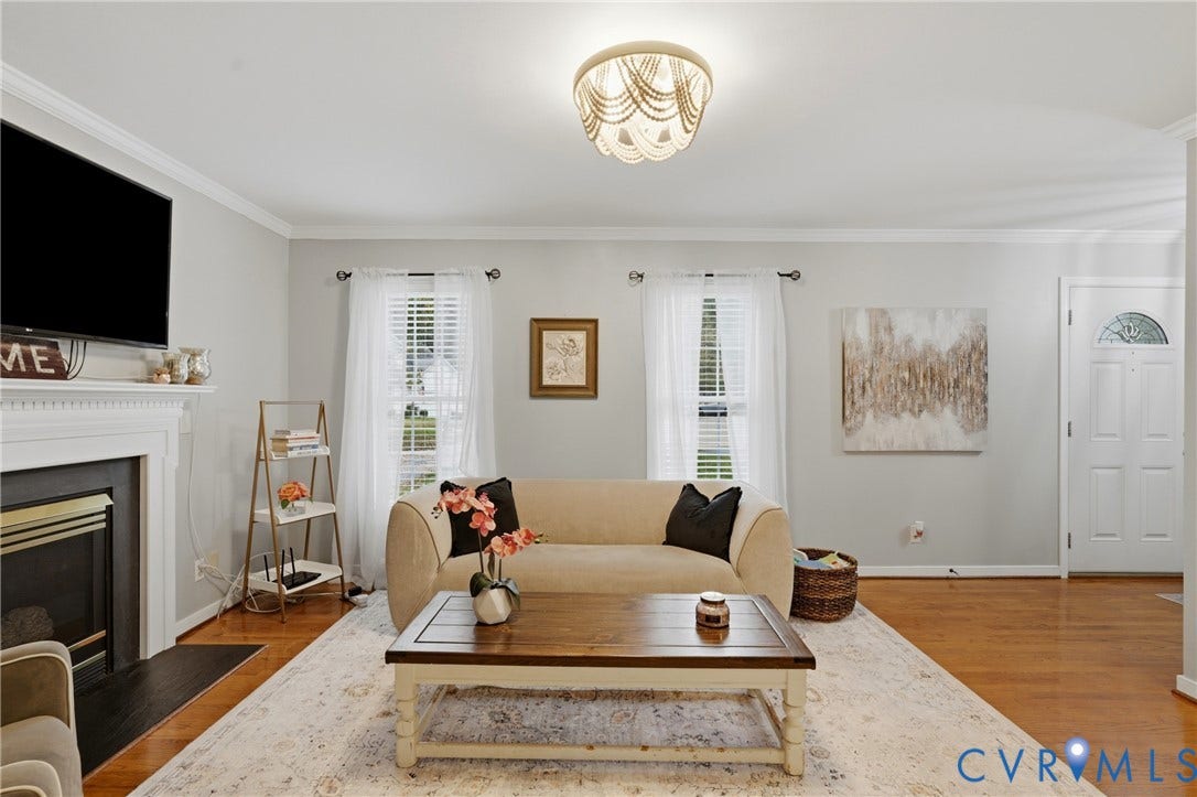 14800 Highberry Woods Drive, Midlothian, VA 23112 Living area featuring wood-finish flooring, a fireplace with a decorative mantel, crown molding, and a beaded semi-flush mount light fixture