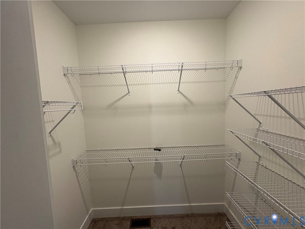 15205 Lebanon Road, Parson's Retreat, Disputanta, VA 23842 Storage area featuring multi-tiered white wire shelving and neutral-toned wall paint