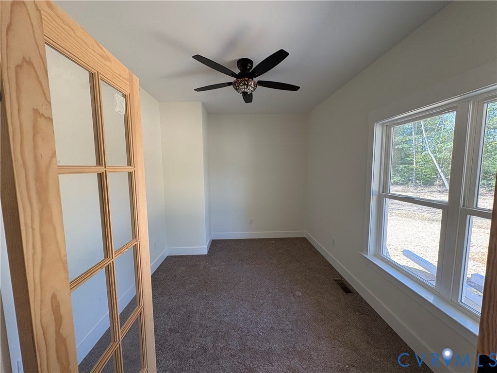 15205 Lebanon Road, Parson's Retreat, Disputanta, VA 23842 Interior room featuring a natural wood-finish French door, multi-pane glass panels, a ceiling fan with light fixture, and large windows