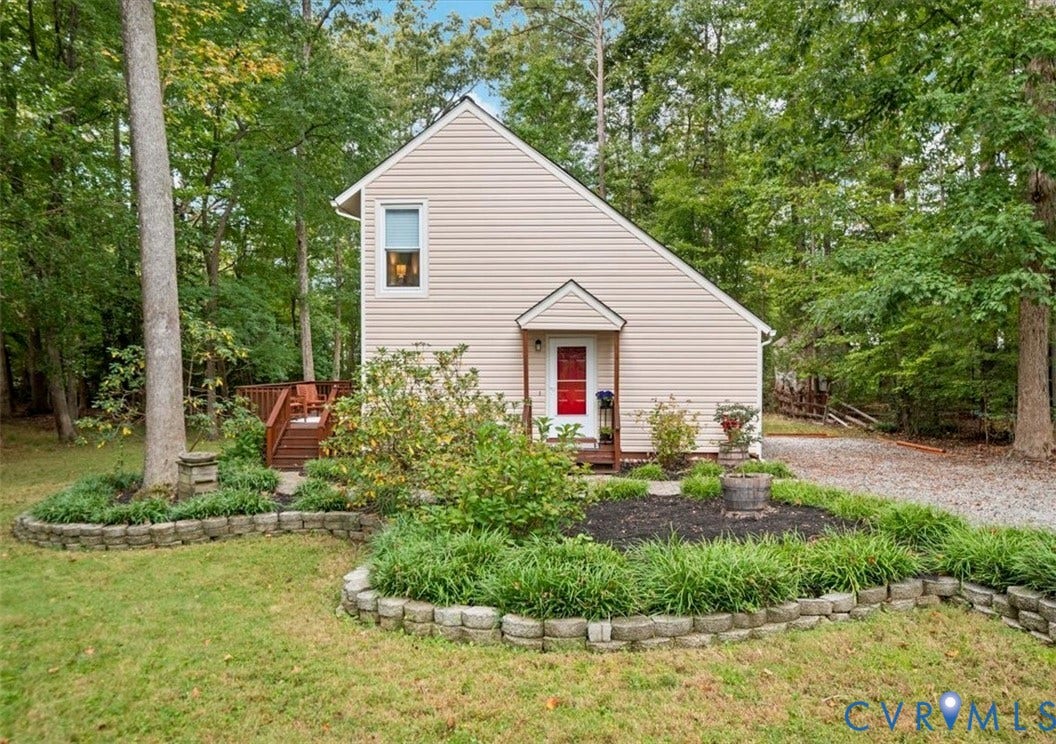 10209 Francill Court, North Chesterfield, VA 23236 Vinyl siding exterior with a gabled roofline, front entryway featuring a covered porch, stone-bordered landscape beds, and a wood-deck platform