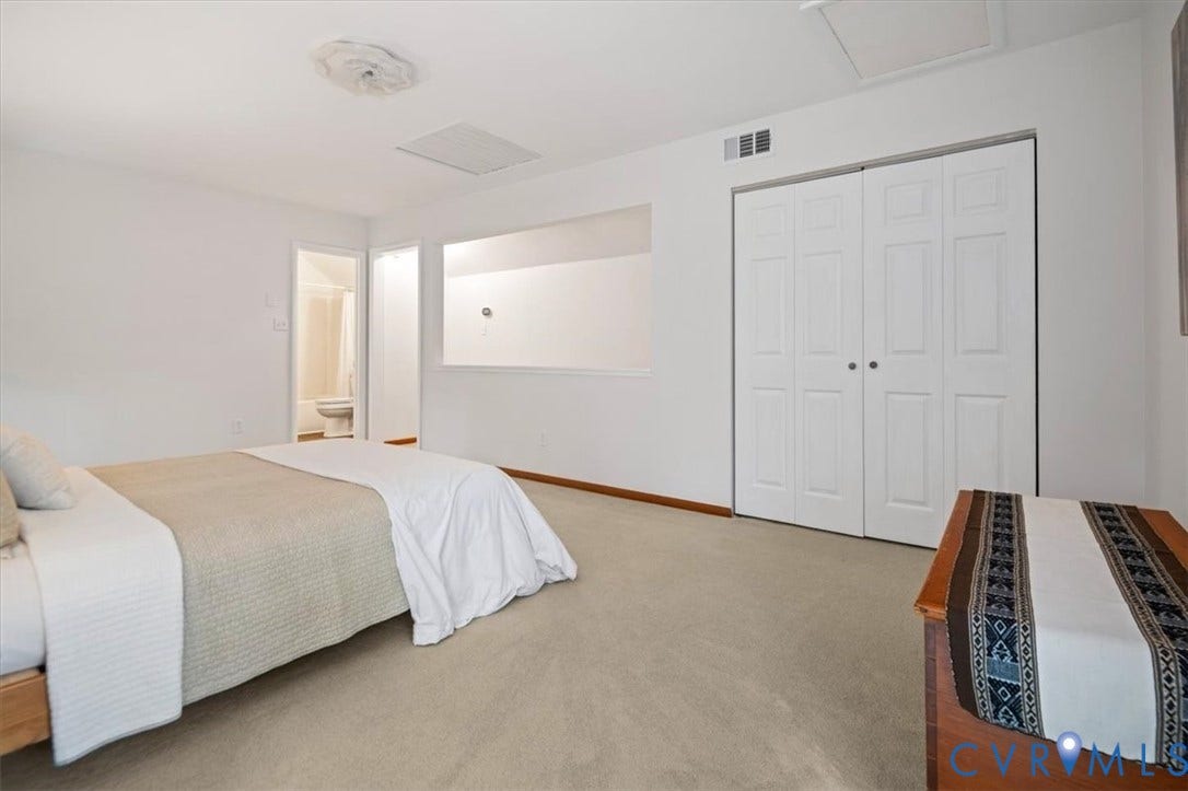 10209 Francill Court, North Chesterfield, VA 23236 Room featuring neutral carpeting, double-door closet with white paneling, decorative ceiling medallion, and a large interior wall opening