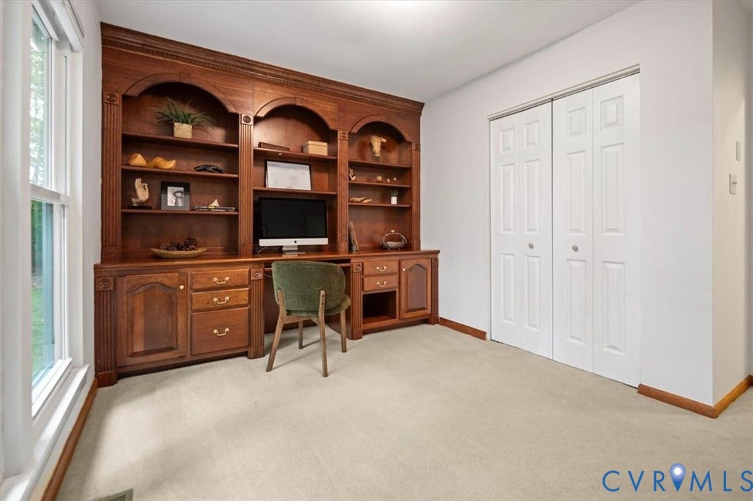 10209 Francill Court, North Chesterfield, VA 23236 Custom wood-finish built-in shelving with arched detailing, integrated desk cabinetry, and a double-door closet