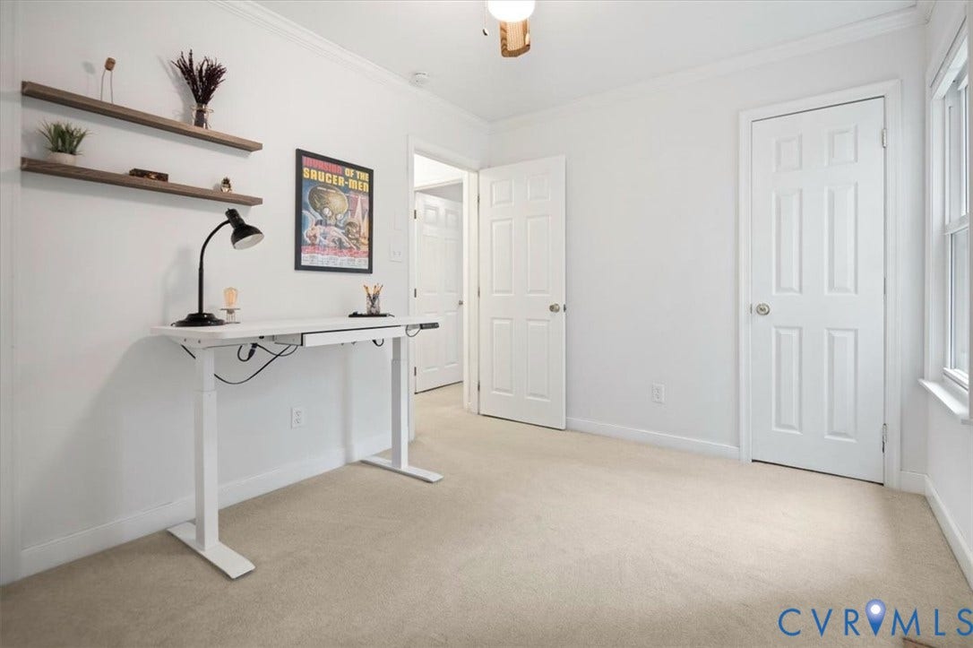 10209 Francill Court, North Chesterfield, VA 23236 Neutral-toned carpeting, two wall-mounted floating wood shelves, six-panel interior doors, and a multi-pane window