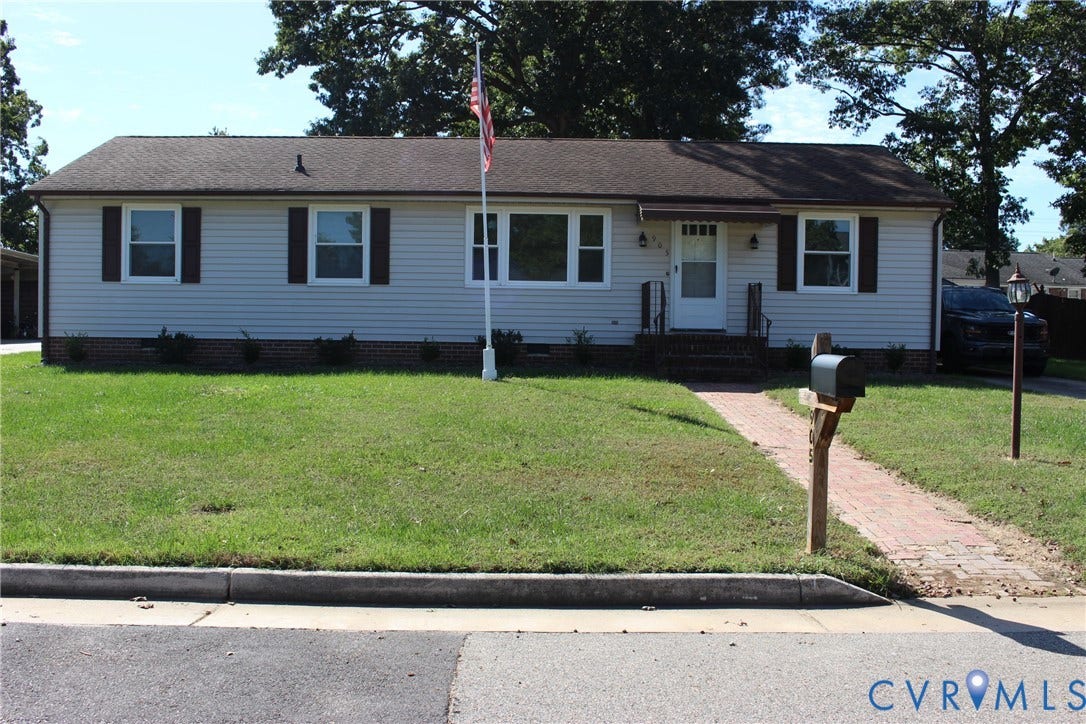 905 Williamsburg Road, Colonial Heights, VA 23834 Single-story residence featuring light-toned vinyl siding, a brick-veneer foundation, contrasting dark shutters, and a front walkway constructed of red brick