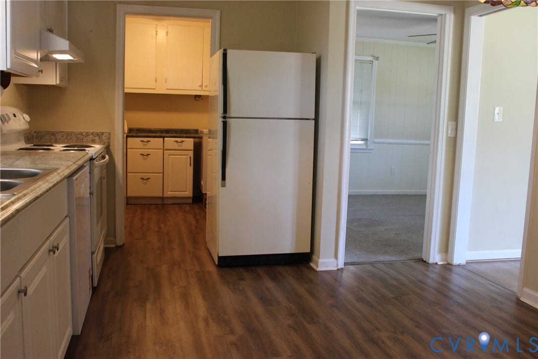 905 Williamsburg Road, Colonial Heights, VA 23834 Kitchen featuring white cabinetry, wood-finish flooring, stone-surfaced countertops, and a full-size refrigerator