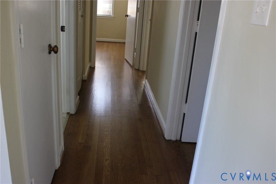 905 Williamsburg Road, Colonial Heights, VA 23834 Hallway featuring wood-finish flooring, neutral wall paint, and multiple interior doors