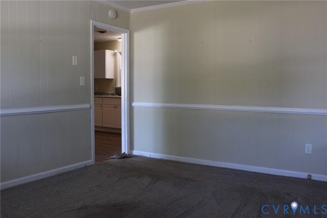905 Williamsburg Road, Colonial Heights, VA 23834 Interior space featuring wall-paneling, chair rail molding, and carpeting