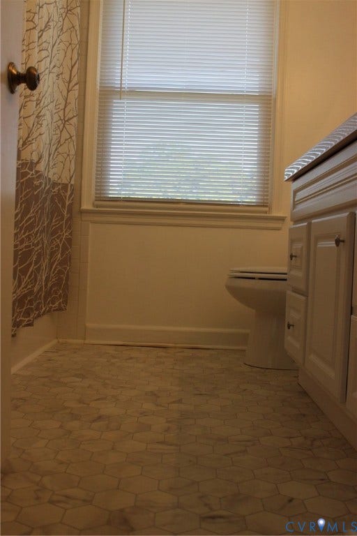 905 Williamsburg Road, Colonial Heights, VA 23834 Bathroom featuring white hexagon floor tile, vanity with cabinetry, and window with built-in blinds