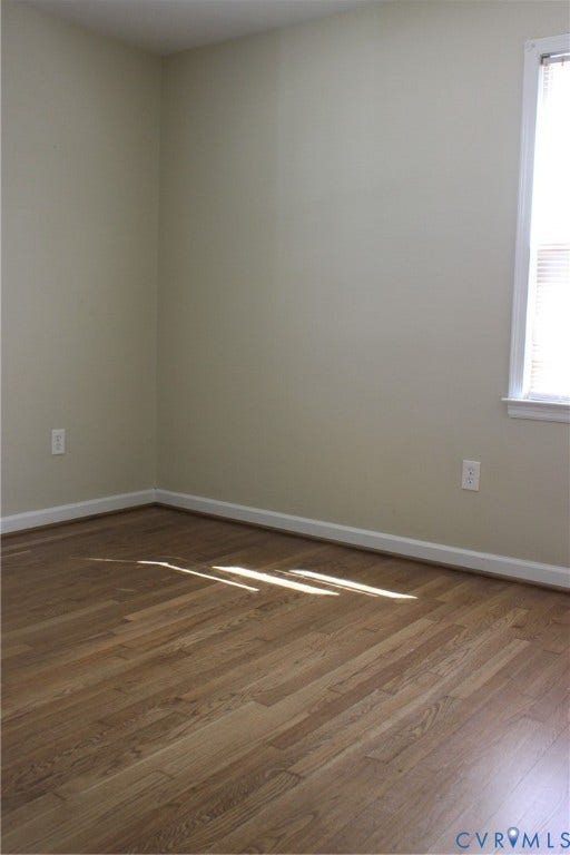 905 Williamsburg Road, Colonial Heights, VA 23834 Interior space featuring wood-finish flooring, neutral wall paint, and a single-pane window