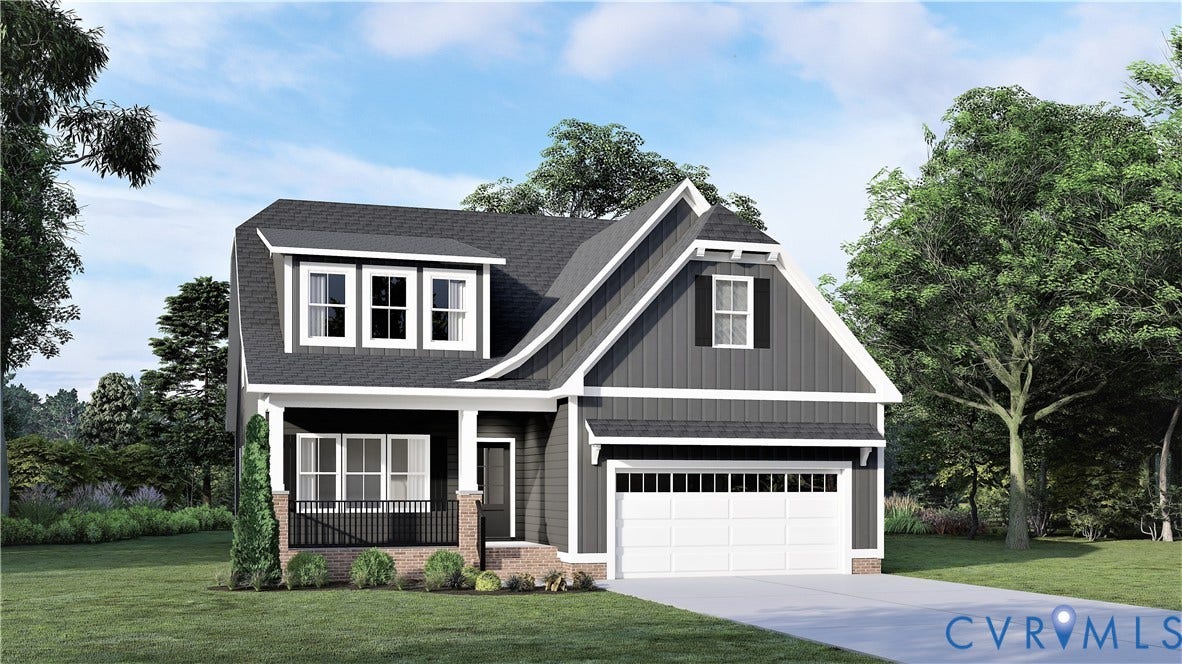 Two-story exterior featuring dark vertical siding, a front covered porch with metal railings and masonry accents, multiple dormer windows, and a two-car attached garage