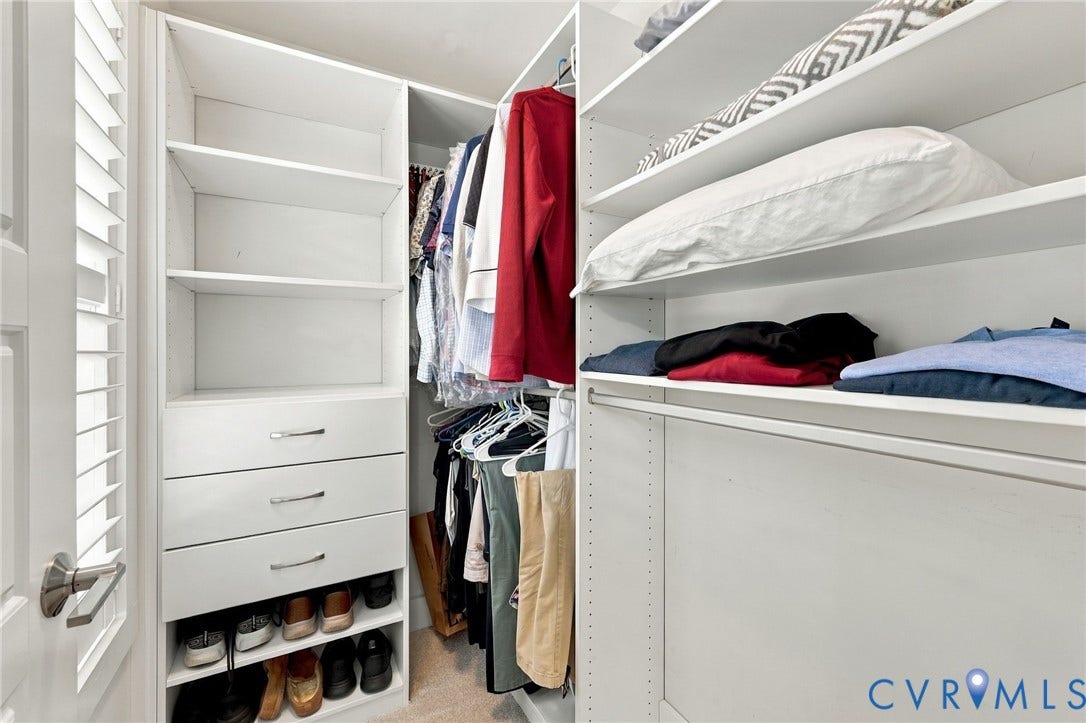 4223 Saunders Tavern Trail, #A, Henrico, VA 23233 Walk-in closet featuring white built-in shelving, integrated dresser drawers with metal pulls, tiered shoe storage, and hanging rods