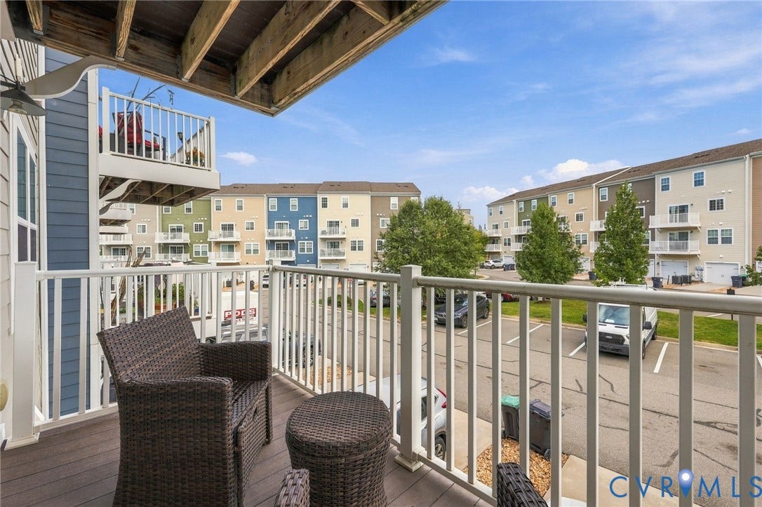 4223 Saunders Tavern Trail, #A, Henrico, VA 23233 Elevated balcony featuring white vertical railings, composite decking, and overhead structural supports