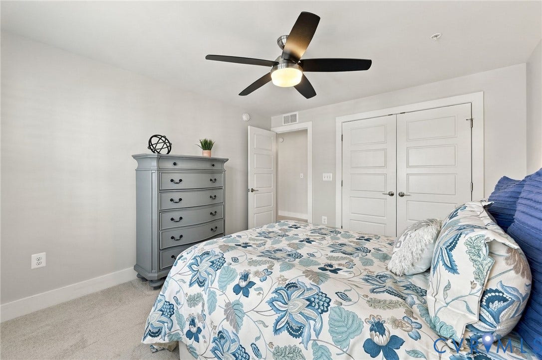 4223 Saunders Tavern Trail, #A, Henrico, VA 23233 Neutral carpeting, multi-panel interior doors, and a brushed nickel ceiling fan with integrated light fixture