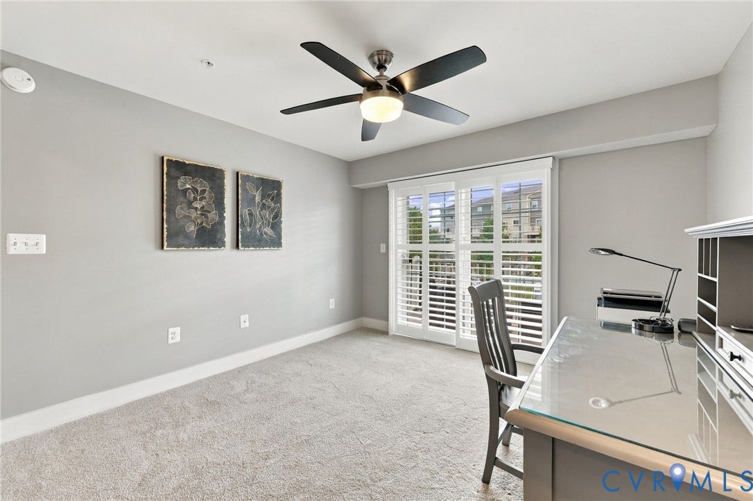 4223 Saunders Tavern Trail, #A, Henrico, VA 23233 Neutral-toned interior space featuring wall-to-wall carpeting, a multi-blade ceiling fan with integrated lighting, and sliding glass doors with plantation-style shutters